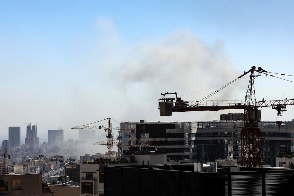 Smoke rises above buildings in Tehran following an Israeli strike on June 18, 2025. (AFP)