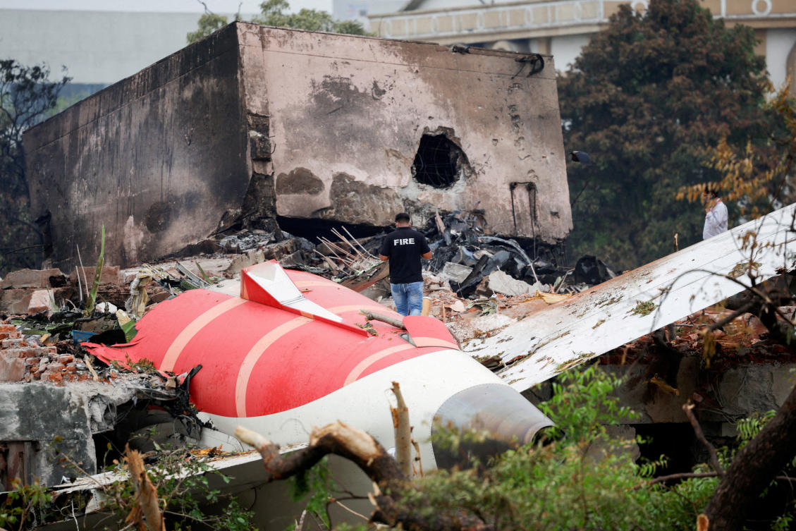 A fire officer stands next to the crashed Air India Boeing 787-8 Dreamliner aircraft in Ahmedabad on June 13, 2025. (Reuters)