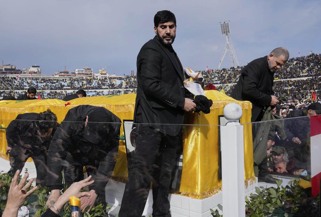 Abu Ali Khalil, center, the bodyguard and the head of security of late Hezbollah leader Hassan Nasrallah who was reportedly killed in an Israeli airstrike while in Iran, Jun. 21, 2025, stands on a trailer carrying the coffins containing the Nasrallah’s body, in Beirut, Feb. 23, 2025. (AP)