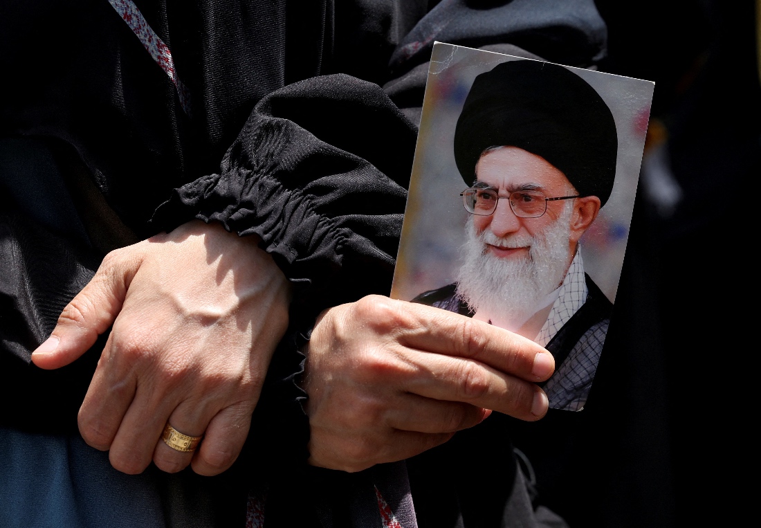 A protestor holds a picture of Iran's Supreme Leader Ayatollah Ali Khamenei as people gather for a rally in solidarity with Iran in the suburbs of Beirut, Lebanon. (Reuters)