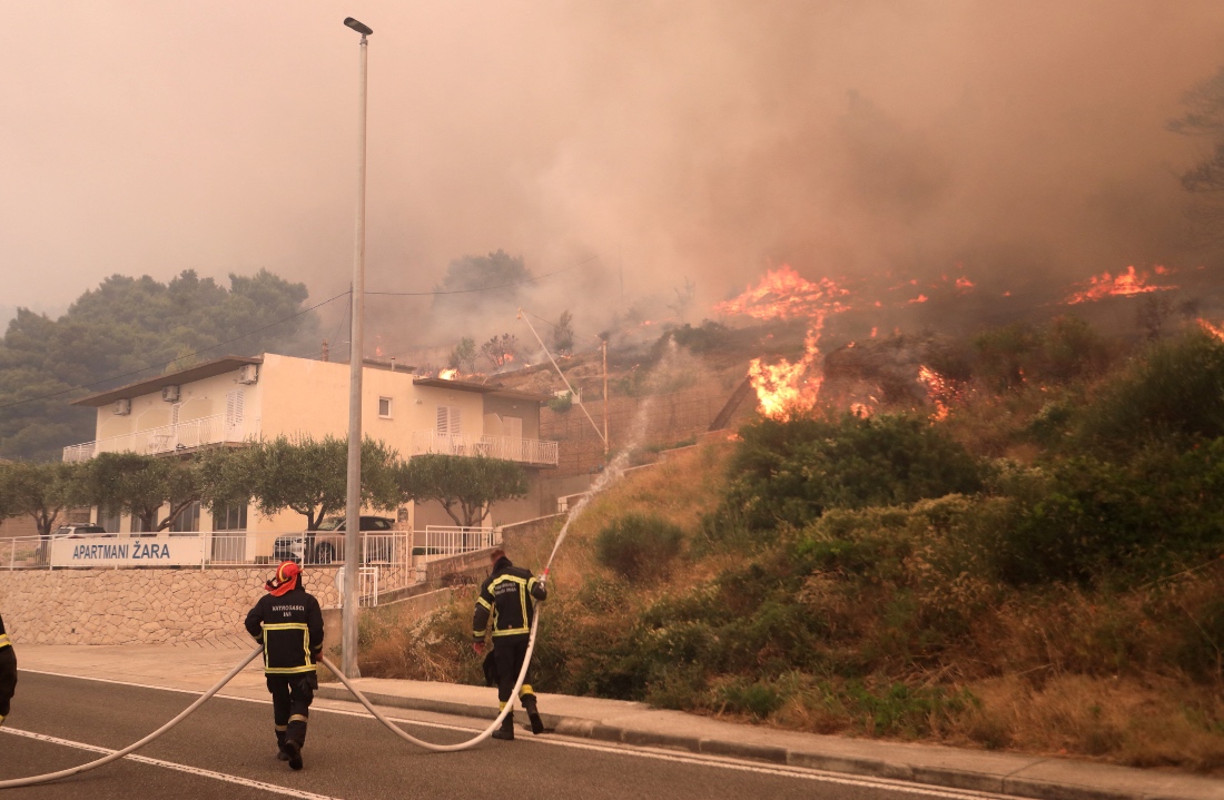 Firefighters attempt to extinguish the wildfire in Pisak, Croatia. (Handout/Reuters)