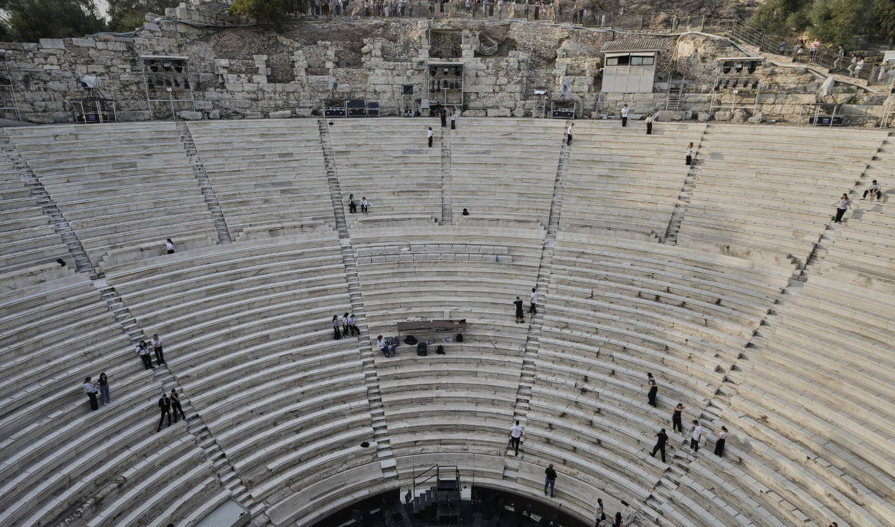 Tourists watch the ushers as they prepare the Odeon of Herodes Atticus ahead of the dress rehearsal of Giacomo Puccini's "Turandot" by the Greek National Opera during the 70th Athens Epidaurus Festival in Athens, Greece, Friday, May 30, 2025. (AP)
