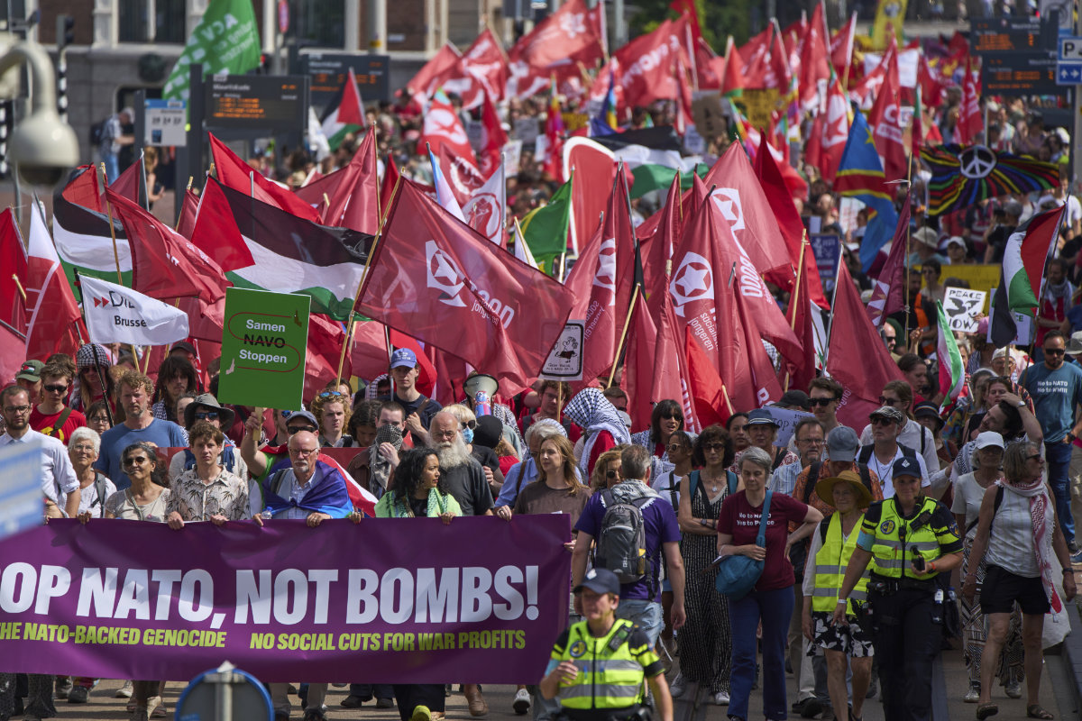 People carry banners and flags during a demonstration ahead of the NATO summit in The Hague, Netherlands, on June 22, 2025. (AP)