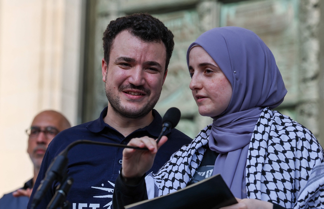 Palestinian activist Mahmoud Khalil stands with his wife Noor Abdalla speaking at a rally on the steps of the Cathedral of St. John the Divine in Manhattan, US. (AFP)
