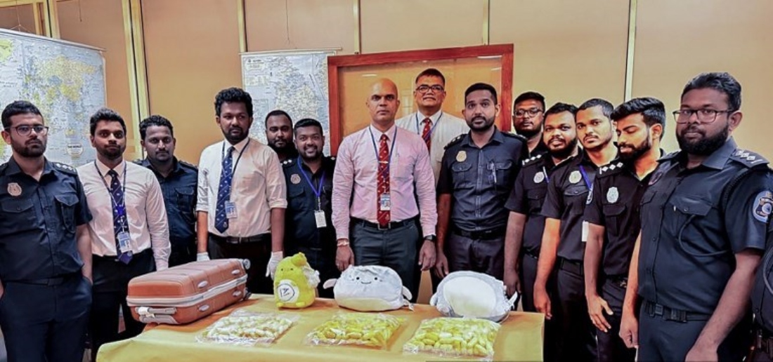 Custom officers pose for a photograph with seized cocaine in Katunayake, Sri Lanka. (Handout/AFP)