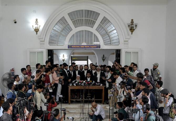 Chief prosecutor of Bangladesh’s International Crimes Tribunal Mohammad Tajul Islam (C) speaks during a press conference outside the ICT court in Dhaka on June 1, 2025, after the start of the trial against former prime minister Sheikh Hasina. (AFP/File)
