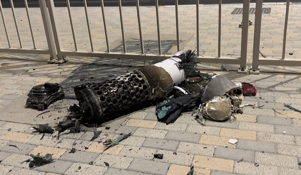 This frame grab take from AFPTV footage shows the remnants of an Iranian missile intercepted over Qatar, as it lies on a pavement near a fence on June 23, 2025. (AFP)