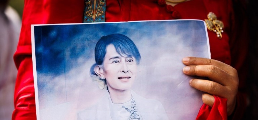 Person holds a photo of Aung San Suu Kyi uring a gathering at the United Nations in 2024 in Bangkok, Thailand. (AFP)