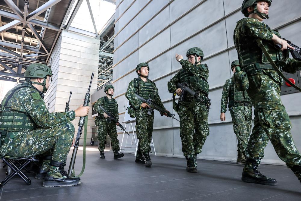 Above, reservists participate in an urban combat training exercise at the Taipei Tennis Center in Taipei’s Neihu District on June 11, 2025. (AFP)