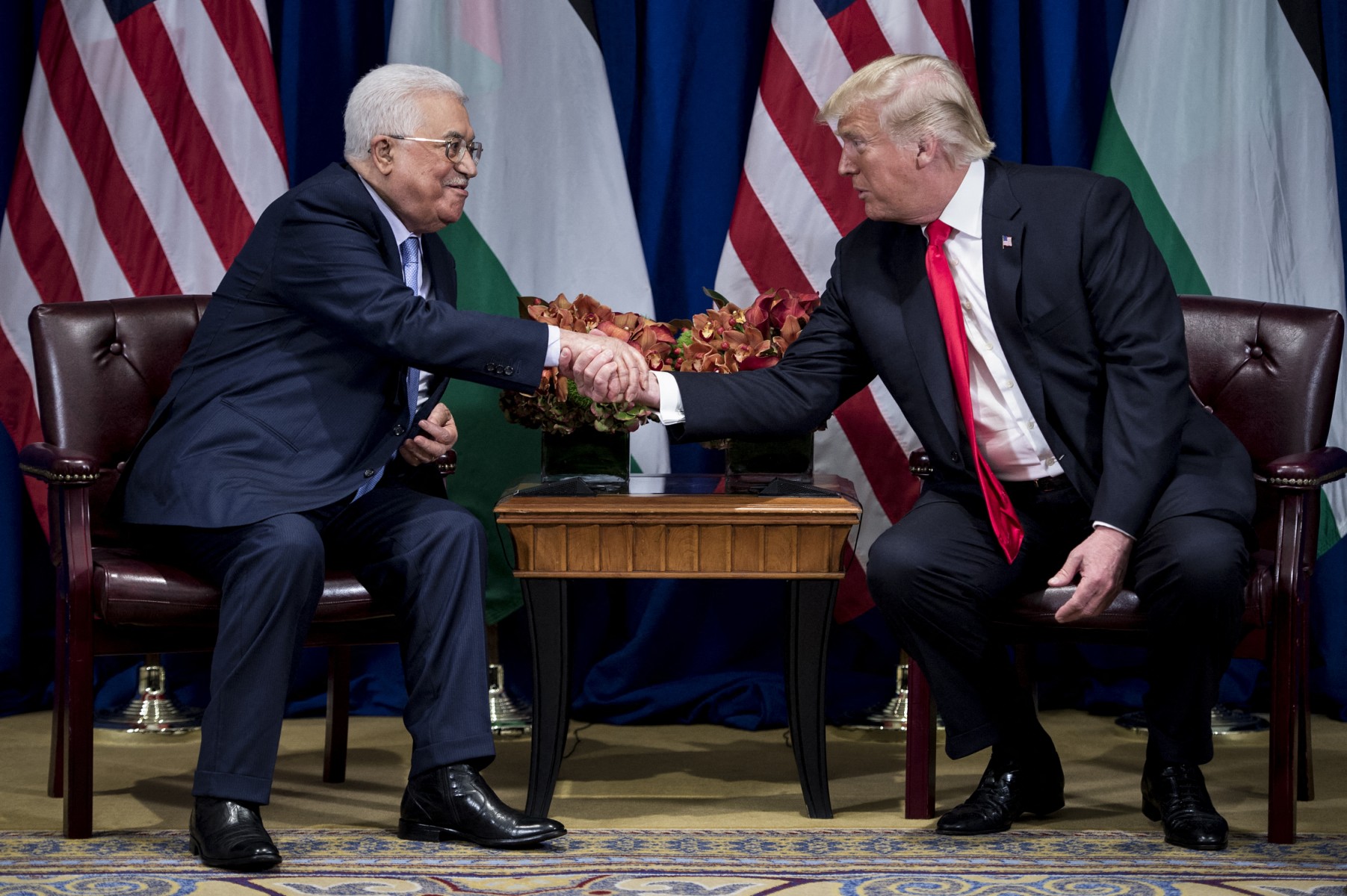 Palestinian Authority President Mahmoud Abbas and US President Donald Trump shake hands before a meeting at the Palace Hotel during the 72nd United Nations General Assembly in New York. (File/AFP)
