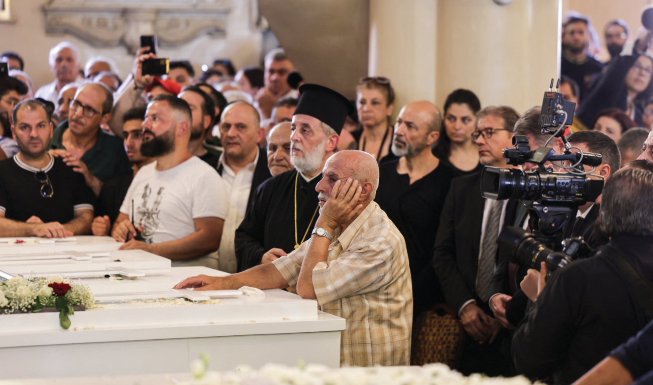 Hundreds were at the service in the Church of the Holy Cross in Damascus to bury nine of the victims of Sunday’s bombing. (AFP)