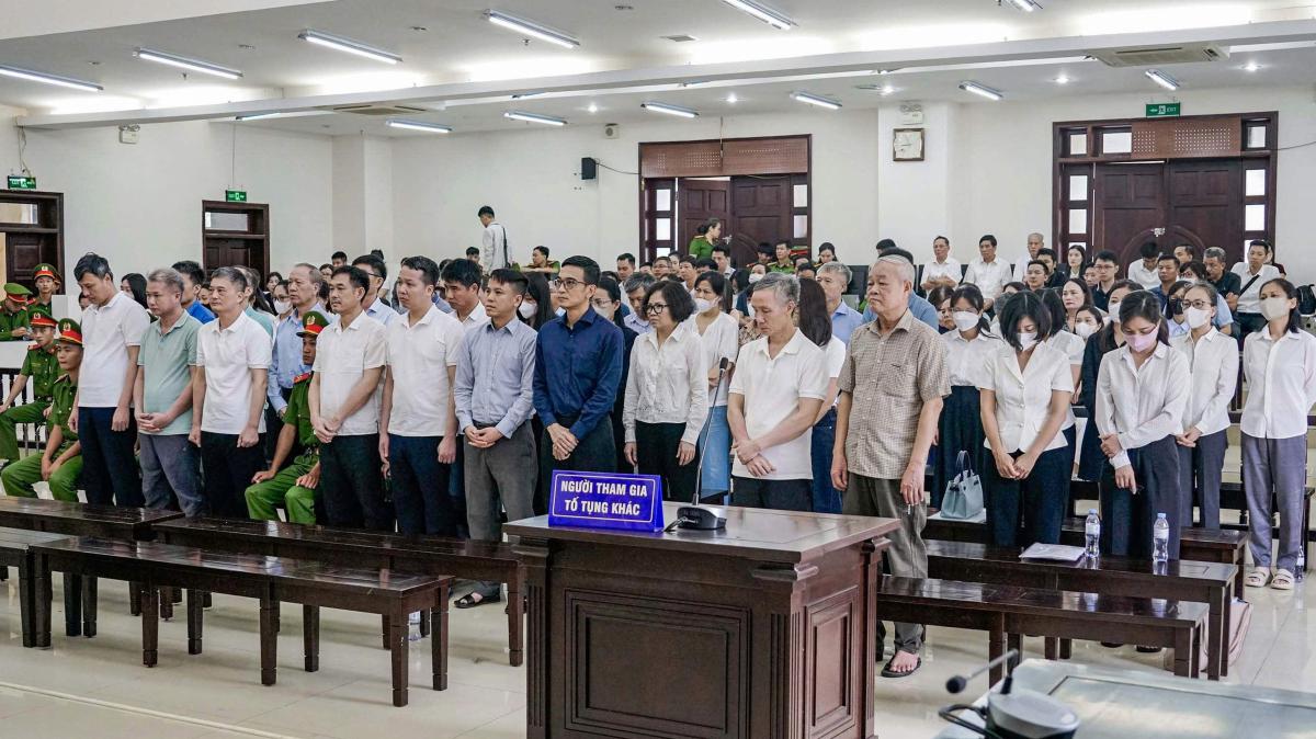 Above, defendants stand during their corruption trial at the High People’s Court in Hanoi on June 26, 2025. (AFP)