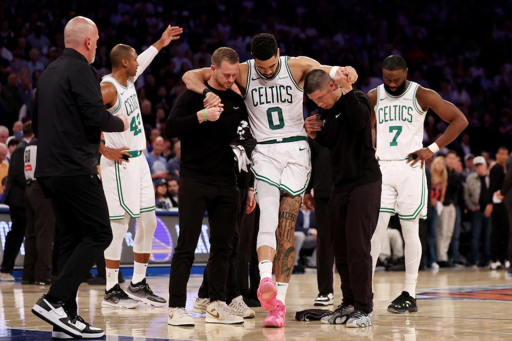 Jayson Tatum of the Boston Celtics is assisted off court after being injured during Game Four of the Eastern Conference Second Round NBA Playoffs against the New York Knicks at Madison Square Garden on May 12, 2025. (Getty Images via AFP)