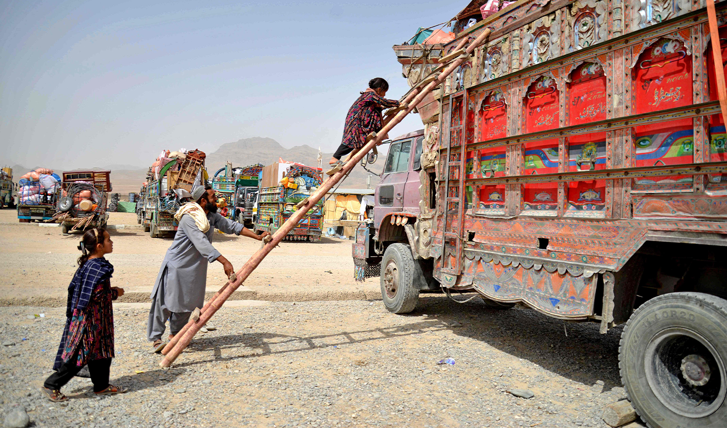 Afghan refugees climb onto a truck upon their arrival from Pakistan, in Takhta Pul district in Kandahar province on June 24, 2025. (AFP)