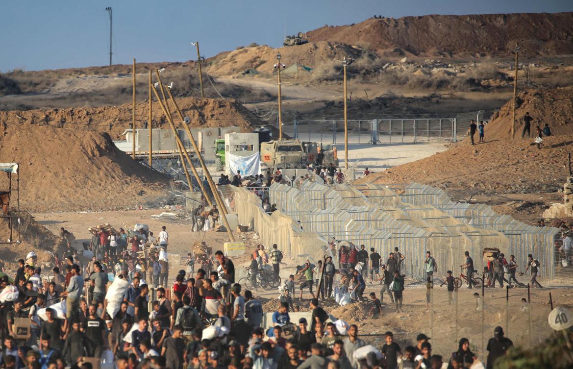 Palestinians gather at an aid distribution point set up by the privately-run Gaza Humanitarian Foundation, near the Nuseirat refugee camp in the central Gaza Strip, June 25, 2025. (AFP)