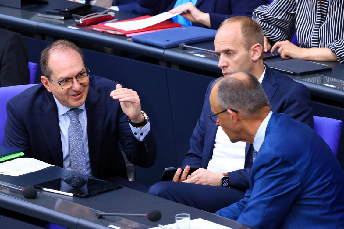 German Interior Minister Alexander Dobrindt speaks with Chancellor Friedrich Merz on the day the Bundestag, votes on a draft bill to suspend family reunification for two years for people granted subsidiary protection status to relieve pressure on Germany's reception and integration systems, in Berlin, Jun. 27, 2025. (Reuters)