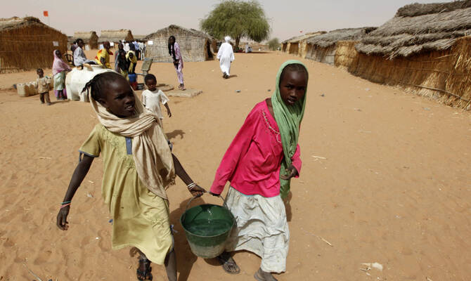 Sudanese refugee girls carry water supplies in the refugee camp of Zamzam, on the outskirts of El-Fasher, Darfur, Sudan. (AP/File)