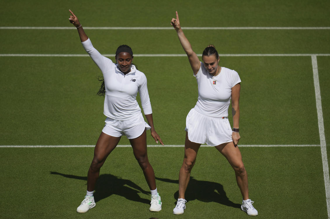 Aryna Sabalenka of Belarus and Coco Gauff of United States dance during a practice session ahead of the Wimbledon Championships in London, Jun. 27, 2025. (AP)
