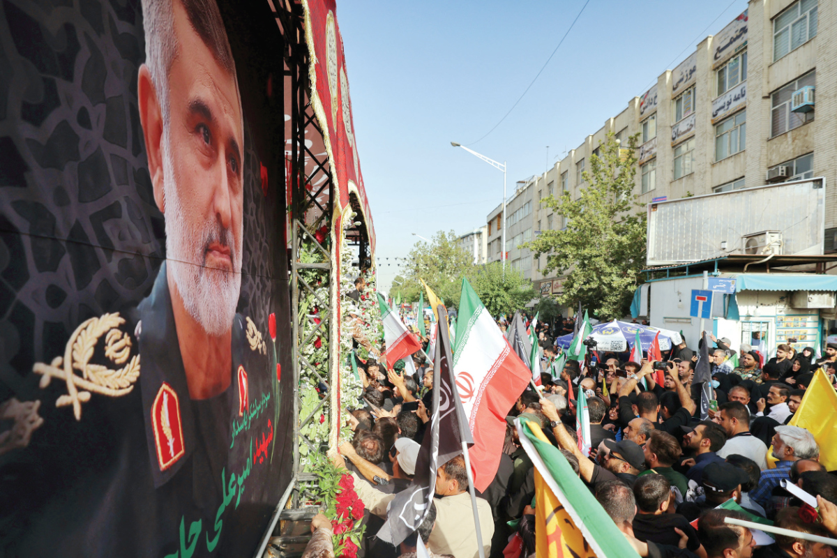 Mourners march during a funeral procession in Tehran on June 28, 2025, for Iranian Revolutionary Guards commander Amir Ali Hjizadeh and other military commanders killed during Israeli strikes on the first day of the war. (AFP)