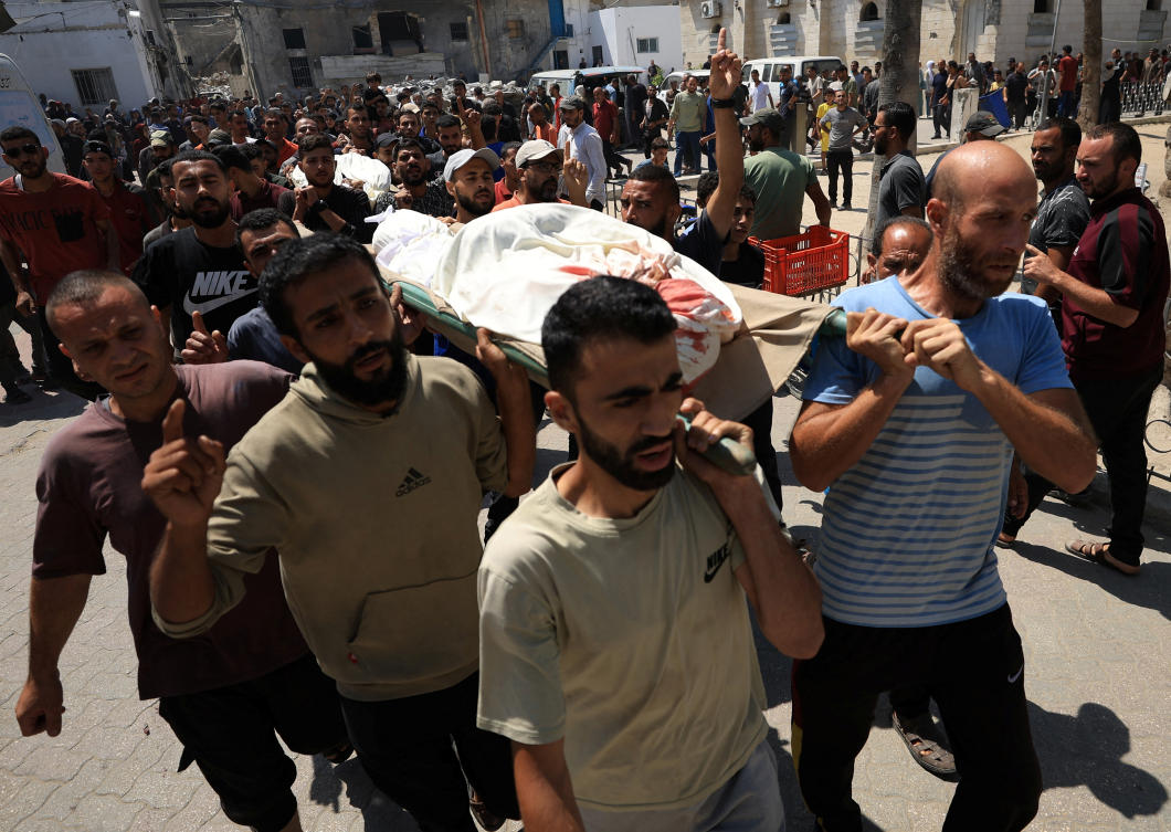 Mourners carry the body of a Palestinian killed in an Israeli strike at Al-Ahli Arab Hospital in Gaza City on June 29, 2025. (Reuters)