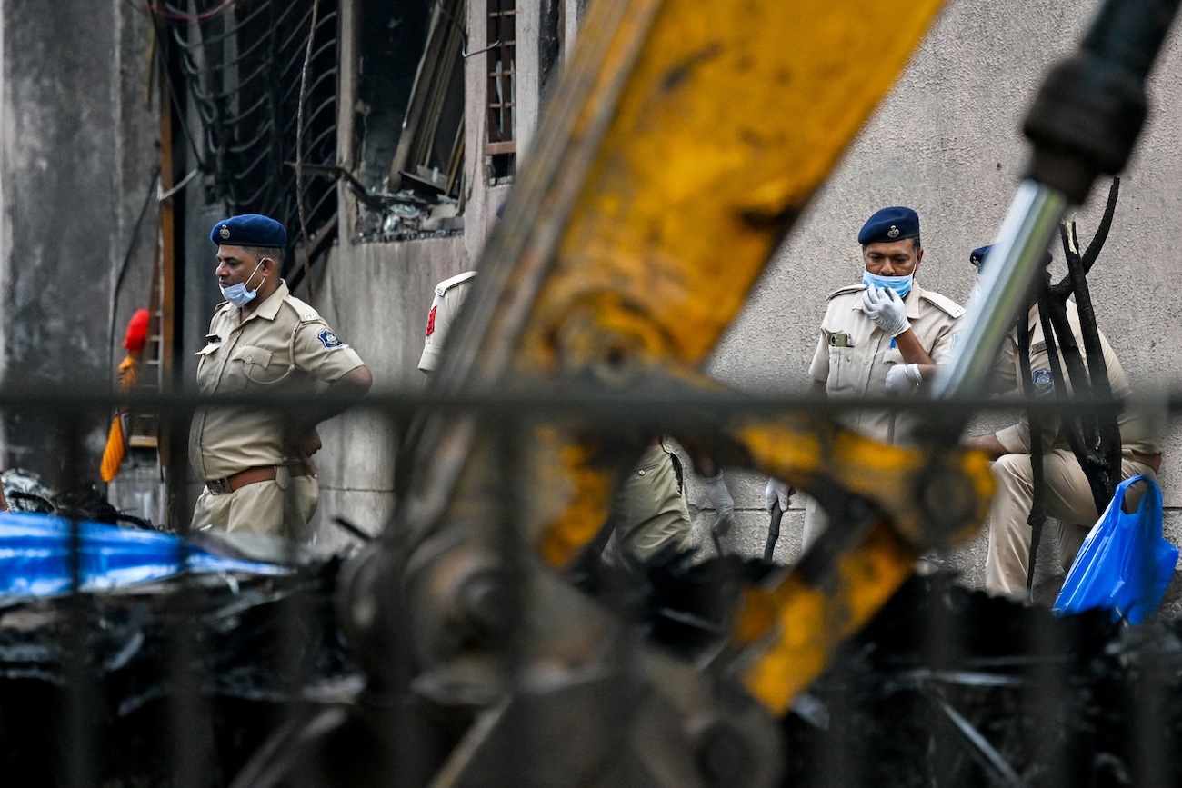 Police personnel inspect the crash site of Air India flight 171 at a residential area near the airport in Ahmedabad on June 15, 2025. (AFP)