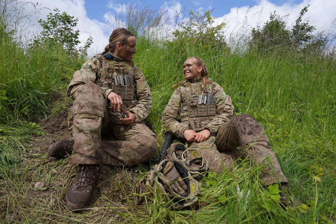 Female conscripts chat together during final exercises at a training area in Hovelte, Denmark. (AP)