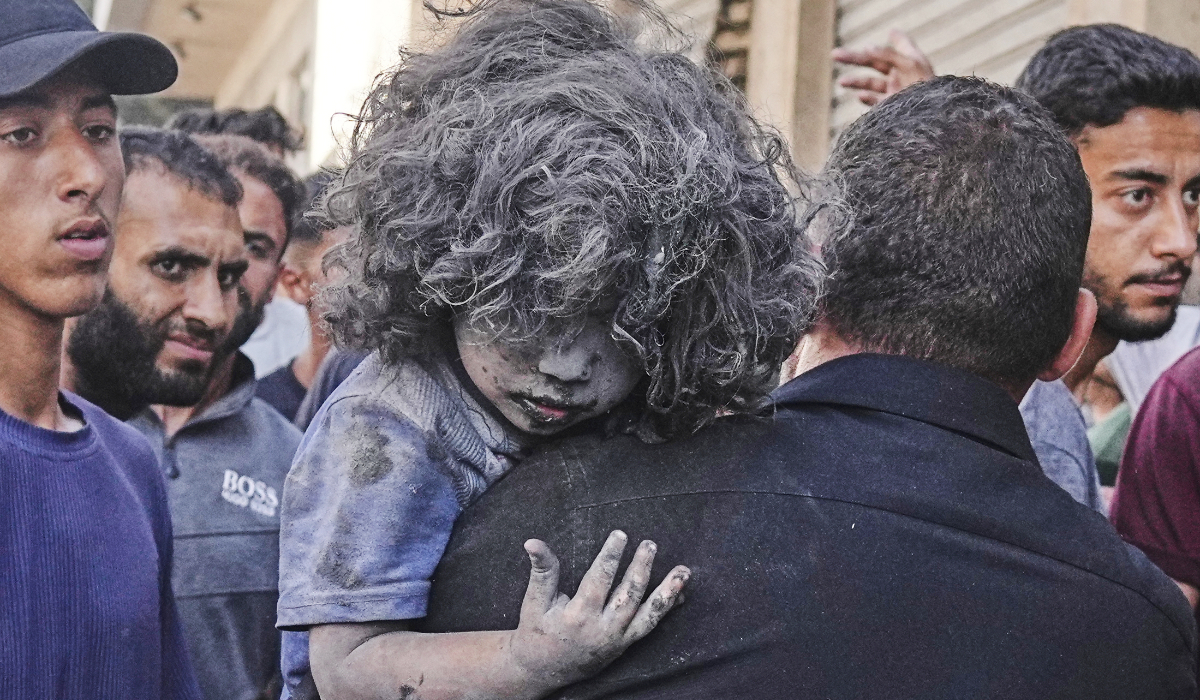 A Palestinian man carries a wounded child after an Israeli strike on a residential building in Gaza, Friday, June 27, 2025. (AP)