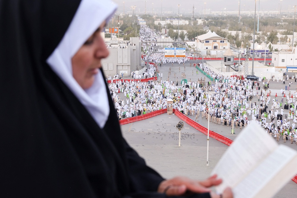 A pilgrim prays on top of Mount Arafat during the annual Hajj pilgrimage on June 5, 2025. (AFP)