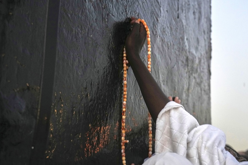 A pilgrim offers prayers on top of Mount Arafat during the annual Hajj pilgrimage on June 5, 2025. (AP)