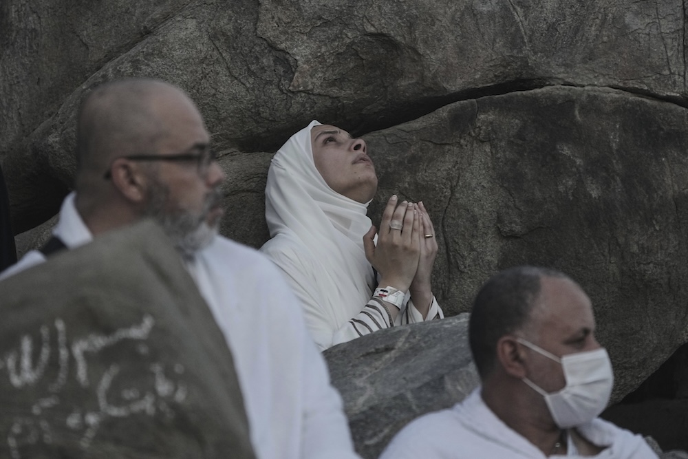 A pilgrim offers prayers on top of Mount Arafat during the annual Hajj pilgrimage on June 5, 2025. (AP)