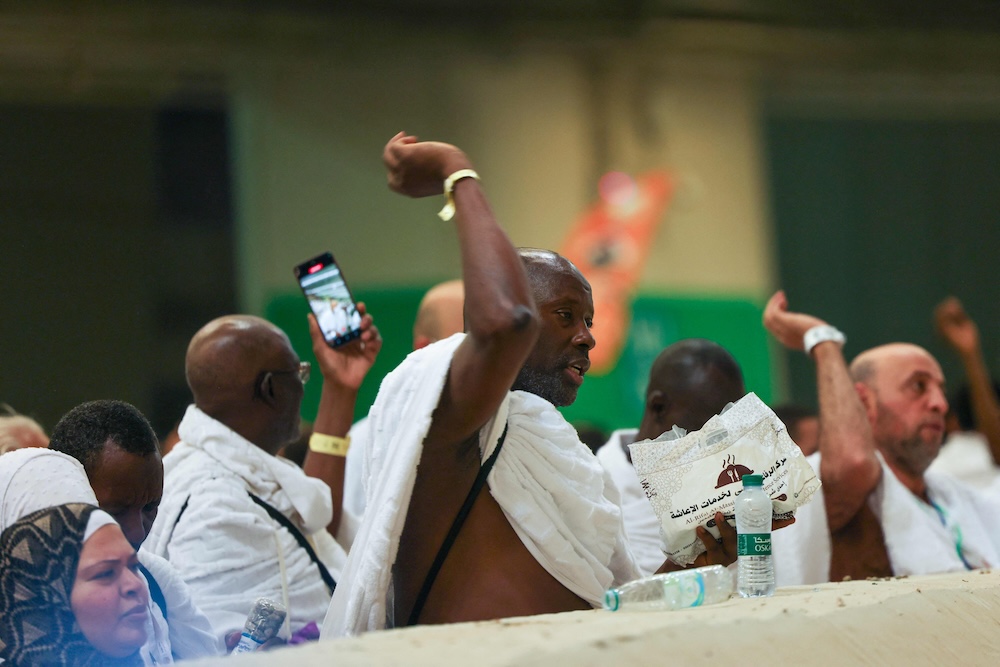 Muslim pilgrims perform the symbolic ‘stoning of the devil’ ritual as part of the hajj pilgrimage in Mina on June 6, 2025. (AFP)