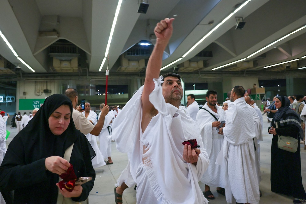 Muslim pilgrims perform the symbolic ‘stoning of the devil’ ritual as part of the hajj pilgrimage in Mina on June 6, 2025. (AFP)