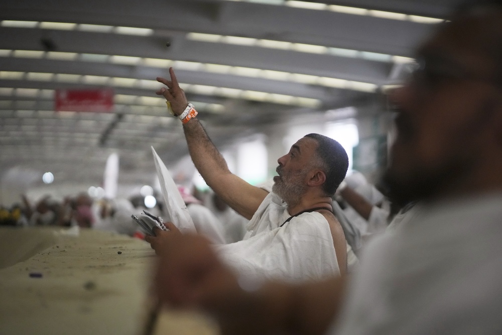 Muslim pilgrims cast stones at pillars in the symbolic stoning of the devil on June 6, 2025. (AP)
