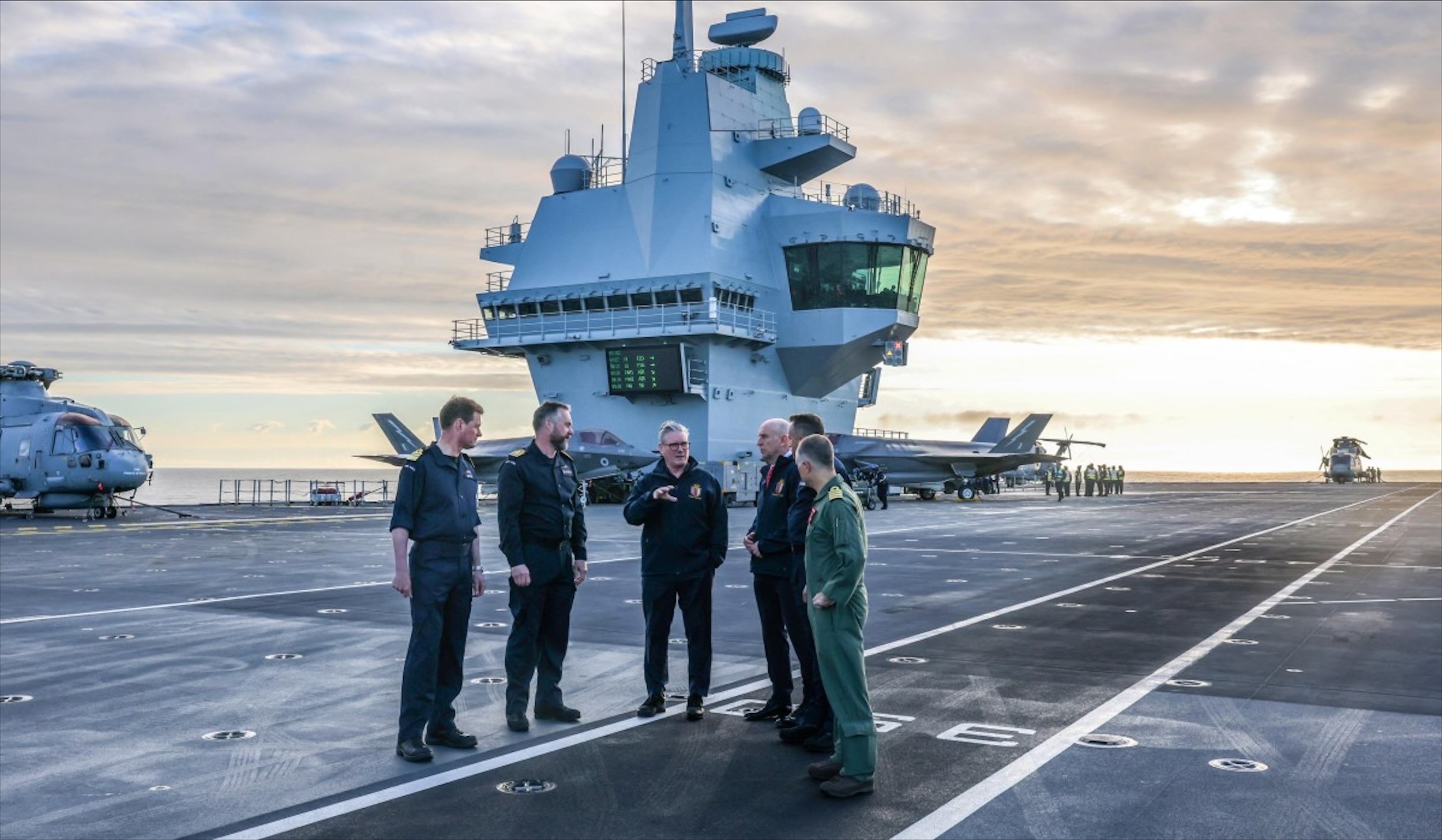 British Prime Minister Keir Starmer and Defence Secretary John Healey on the deck of HMS Prince Of Wales. (AFP)
