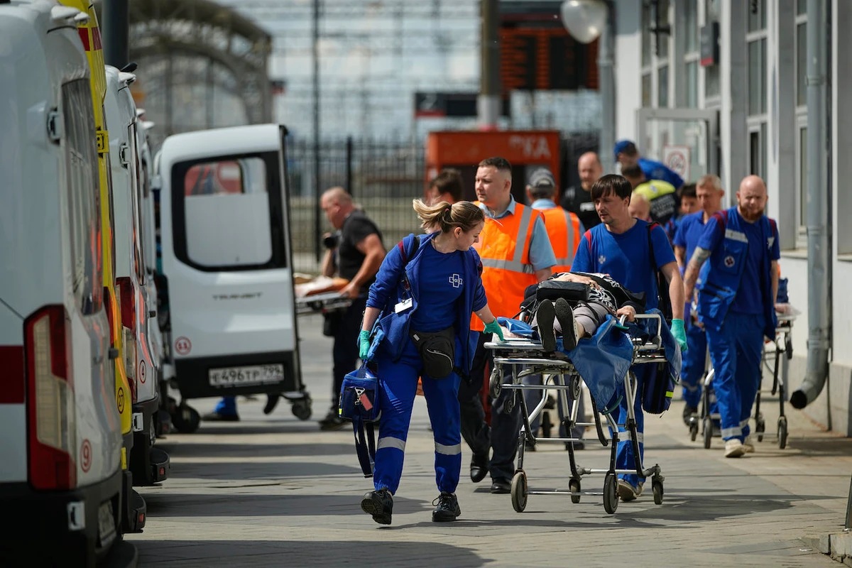 Emergency medics transport a wounded passenger after a road bridge collapsed on top of a passenger train in the Bryansk region, June 1. (AP)