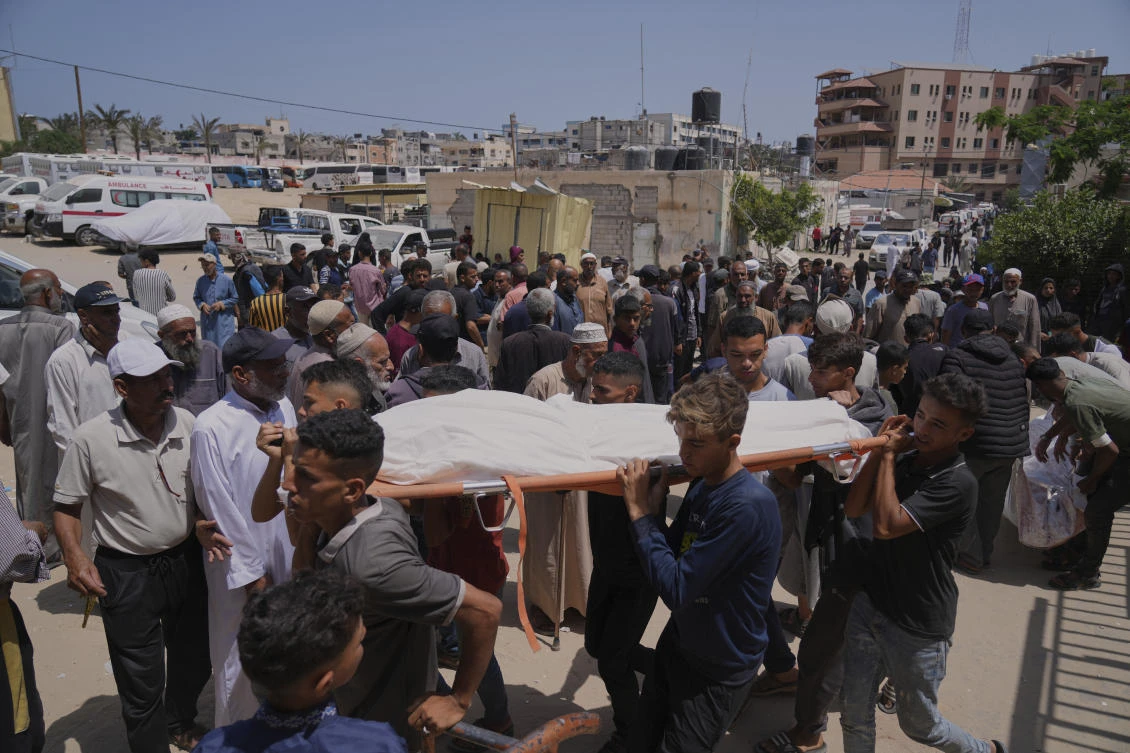 Palestinians carry the body of a person who was killed while heading to a Gaza aid hub, during a funeral at the Nasser Hospital in Khan Younis, southern Gaza Strip, on Sunday. (AP)