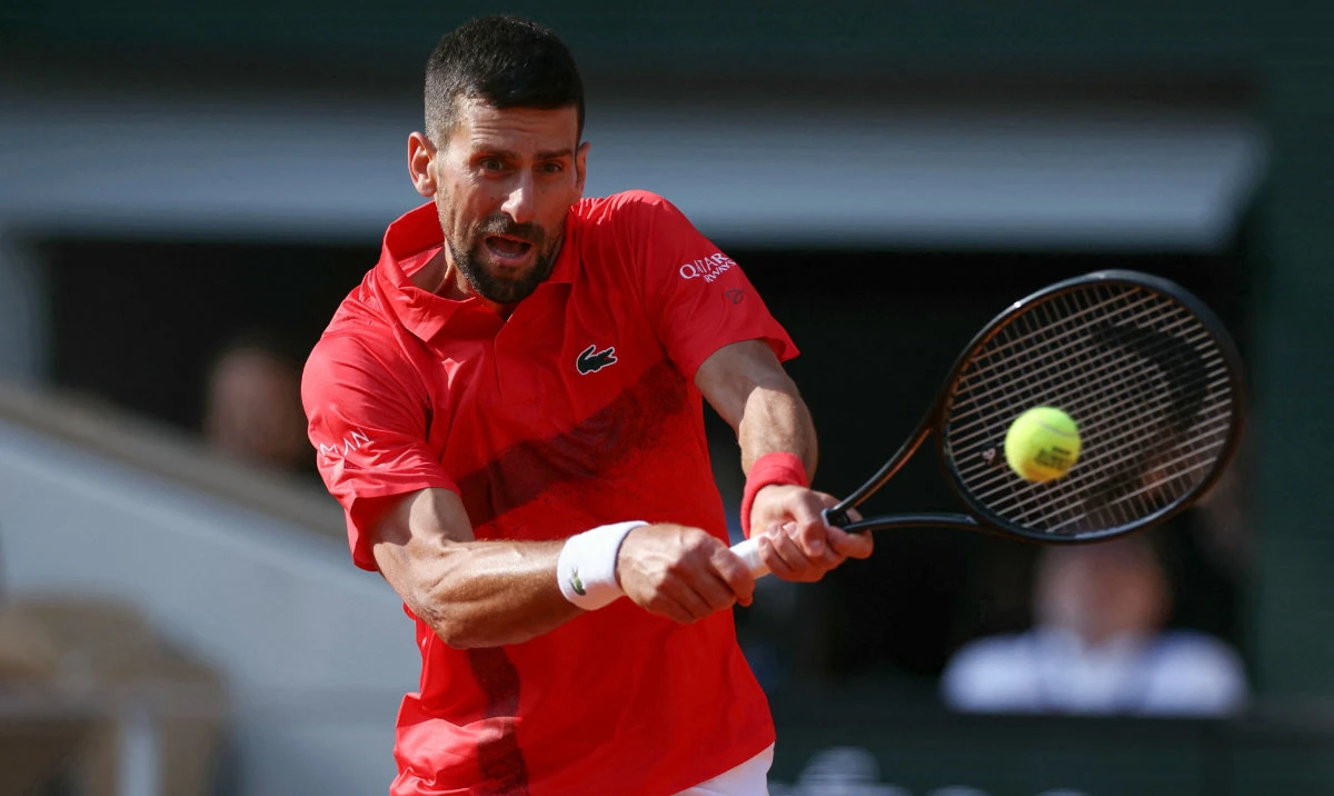 Serbia's Novak Djokovic plays a backhand return to Britain's Cameron Norrie during their men's singles match on day 9 of the French Open tennis tournament on Court Philippe-Chatrier at the Roland-Garros Complex in Paris on June 2, 2025. (AFP)