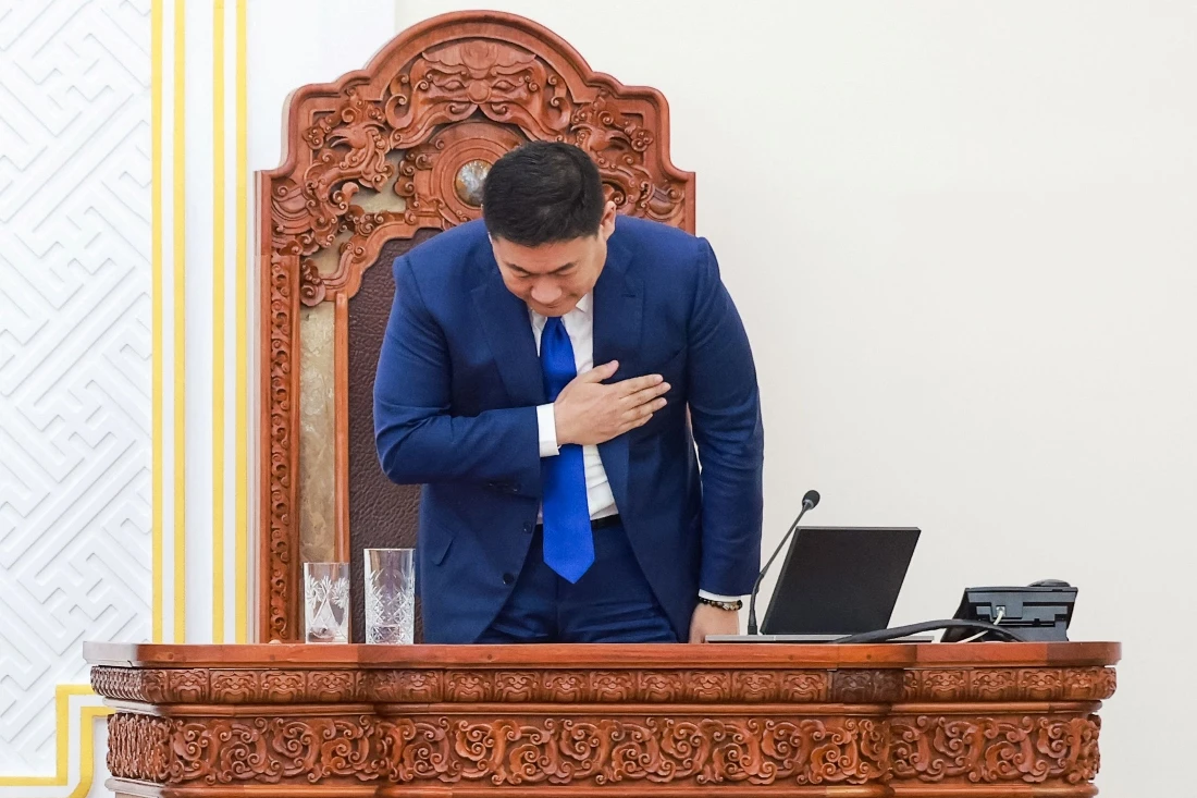Mongolia's Prime Minister Luvsannamsrain Oyun-Erdene takes a bow after losing his position in a vote in Ulaanbaatar, Mongolia. (AFP)
