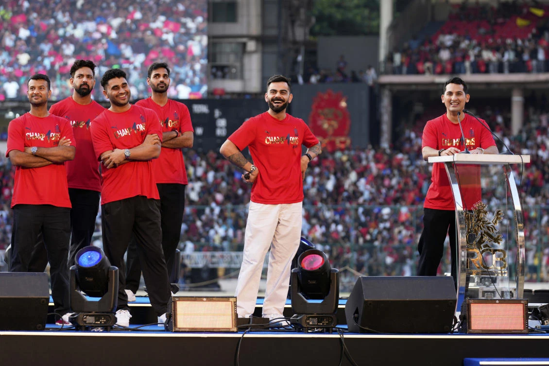 Royal Challengers Bengaluru’s Virat Kohli, center, stands on stage at M. Chinnaswamy Stadium as fans celebrate their team’s win in the Indian Premier League cricket tournament, in Bengaluru, Jun. 4, 2025. (AP)