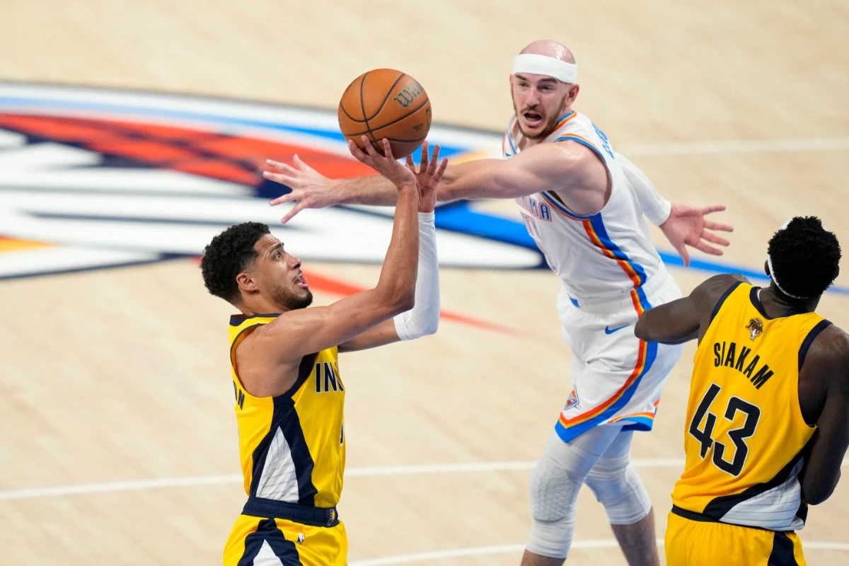 Indiana Pacers guard Tyrese Haliburton (0) drives to the basket against Oklahoma City Thunder guard Alex Caruso (9) during the fourth quarter in Game One of the 2025 NBA Finals at Paycom Center. (Kyle Terada-Imagn Images)