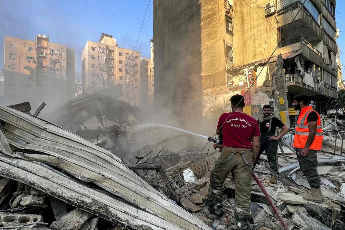 Civil defense members and firefighters extinguish a blaze at the site of an overnight Israeli airstrike on a building in the Qaem neighborhood of Beirut’s southern suburbs on June 6, 2025. (AFP)