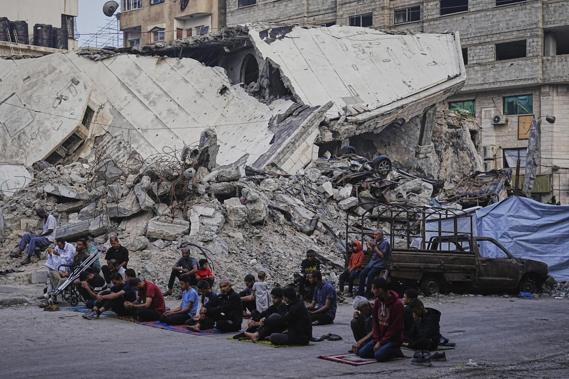 Palestinians gather for Eid Al-Adha prayers beside the ruins of Al-Kanz mosque destroyed by Israeli bombardment in Gaza City on June 6, 2025. (AP)