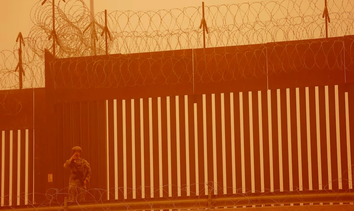 A Texas National Guard soldier stands near the wall on the border between Mexico and US during a sandstorm, as seen from Ciudad Juarez, Mexico. (Reuters/File)