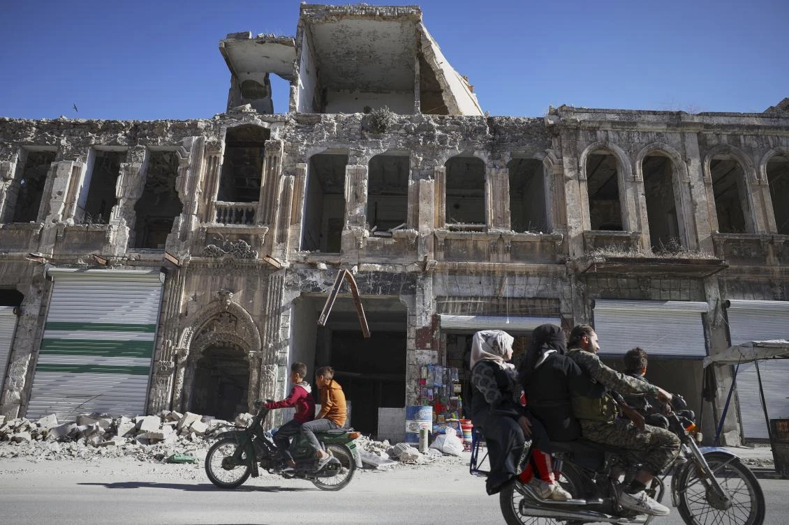 Residents drive past the war-damaged ancient market of Maarat al-Numan, near the site where a Byzantine underground tomb complex, believed to be over 1,500 years old, was uncovered by a contractor during the reconstruction of a war-damaged house, in Maarat al-Numan, Idlib suburb, Syria, on Friday, May 30, 2025. (AP)