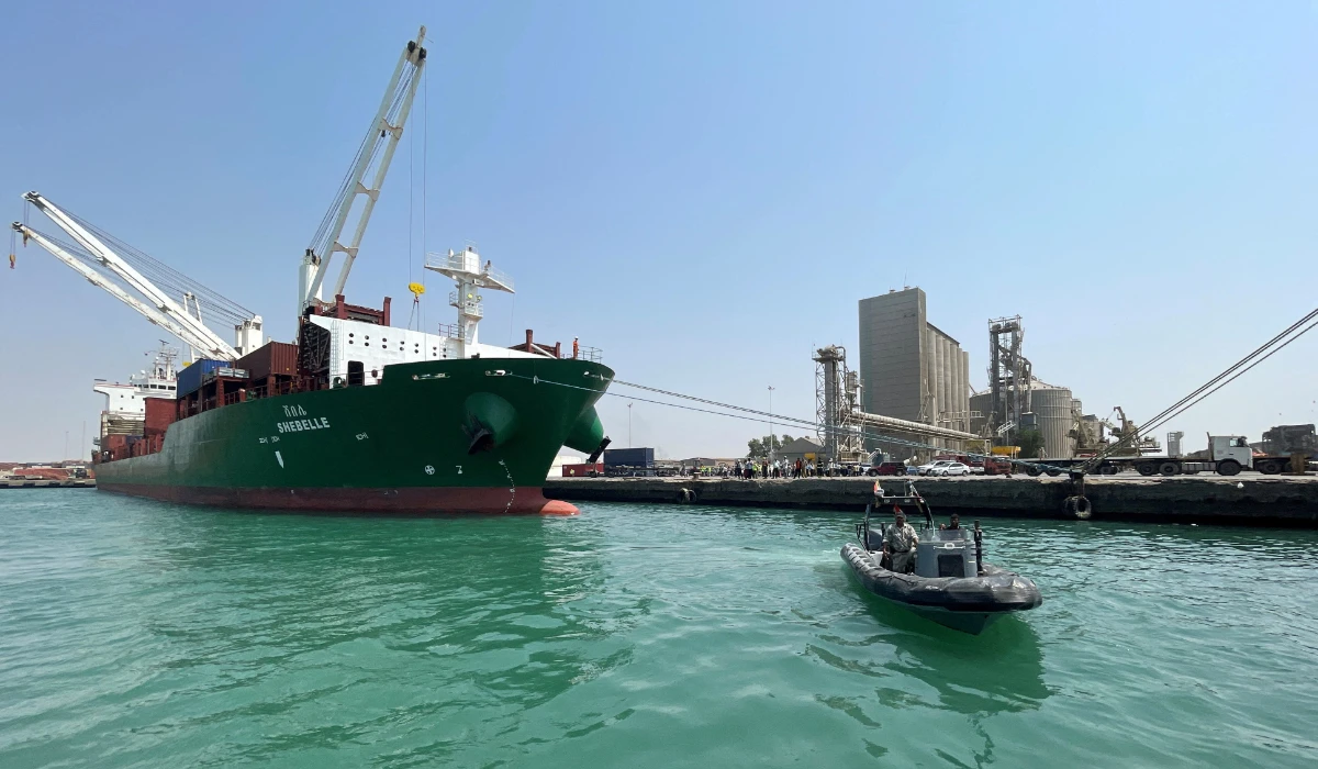 A coastguard boat sails past a commercial container ship docked at the Houthi-held Red Sea port of Hodeidah, as a container ship carrying general commercial goods docked at the port for the first time since at least 2016, in Hodeidah, Yemen February 25, 2023. (REUTERS)