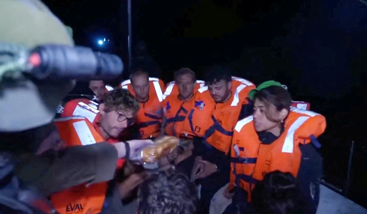 An Israeli solider passes food to those onboard the Gaza-bound British-flagged yacht "Madleen" after Israeli forces boarded the charity vessel as it attempted to reach the Gaza Strip in defiance of an Israeli naval blockade, in this screengrab from video released on June 9, 2025. (REUTERS)