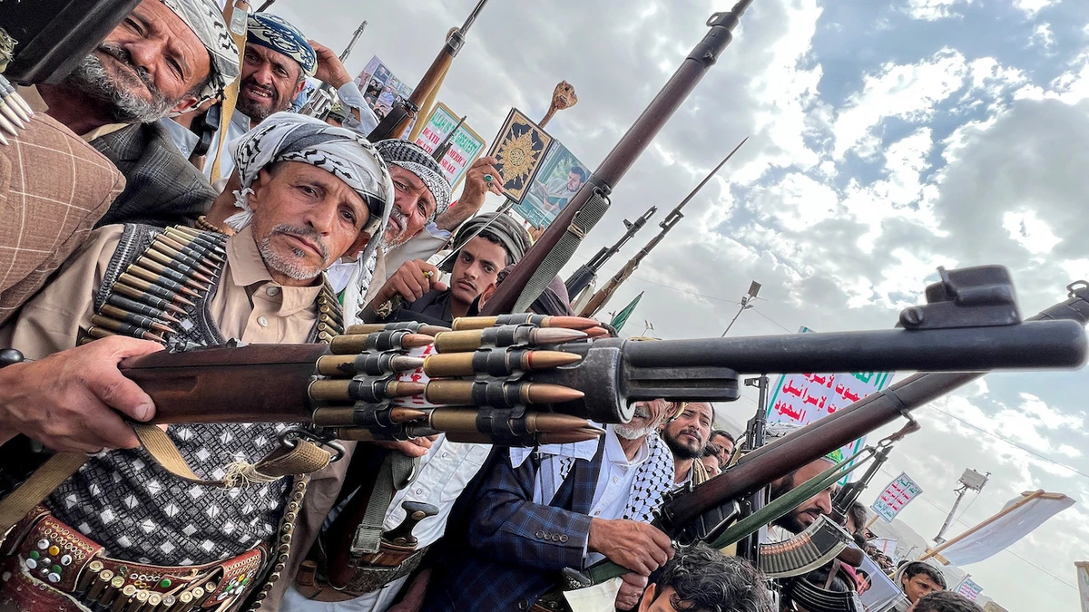 Protesters hold weapons, during a demonstration of predominantly Houthi supporters to condemn US strikes in Yemen, in Sanaa. (File/Reuters)