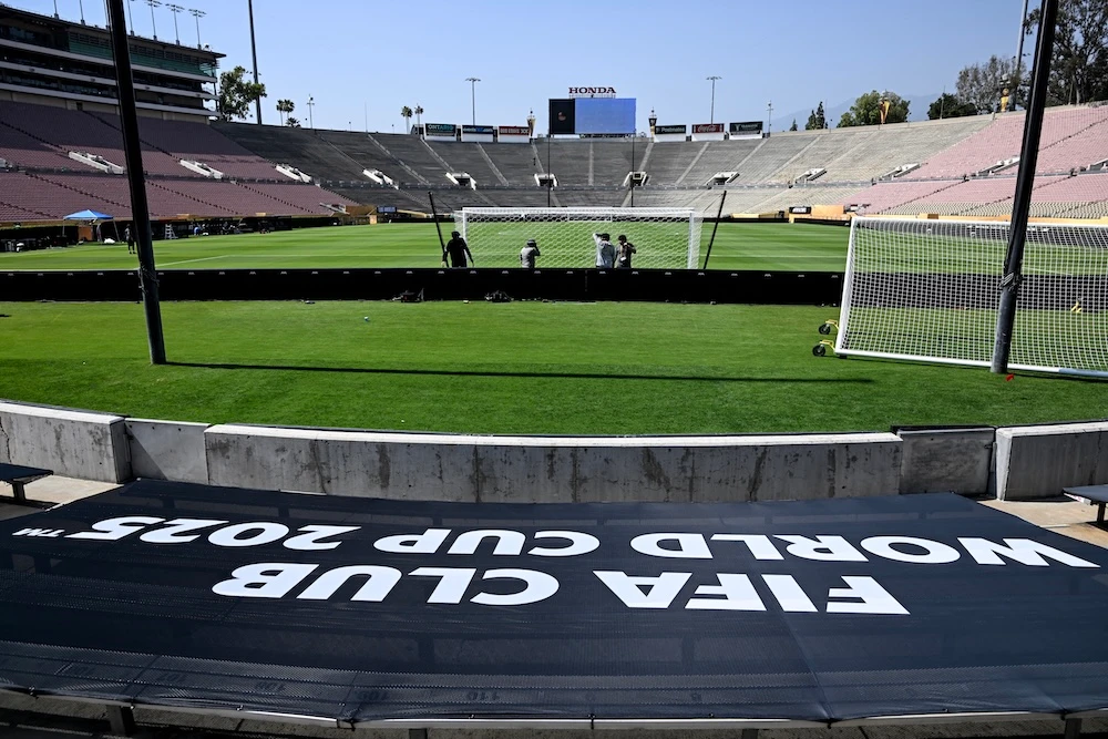 Workers install a goal at the Rose Bowl Stadium ahead of the Club World Cup 2025 football match between Paris Saint-Germain and Atletico de Madrid in Pasadena, California. (AFP)