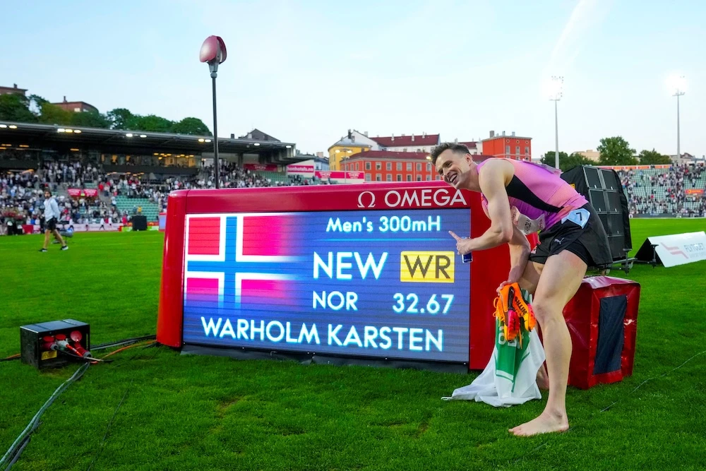 Norway’s Karsten Warholm poses with the scoreboard after setting a new world record and winning the men’s 300m hurdles at the Oslo Diamond League athletics meeting Thursday. (NTB via Reuters)