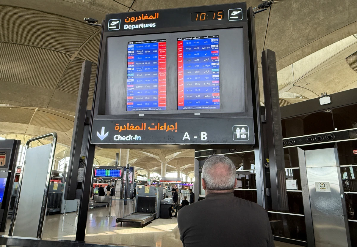 Flight information display screens show information about delayed and cancelled flights, at Queen Alia International Airport in Amman. (Reuters)